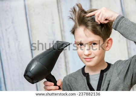 The young boy with black blow dryer