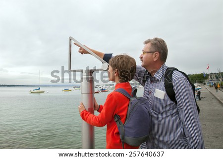The grandfather and boy measure altitude by mechanical tool