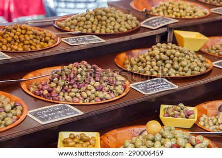 The counter with marinate olives on rural market