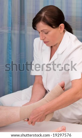 nurse bandaging foot and ankle