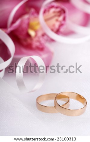 stock photo wedding rings close up with flowers