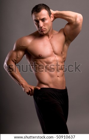 stock photo Portrait of young bodybuilder man on grey background