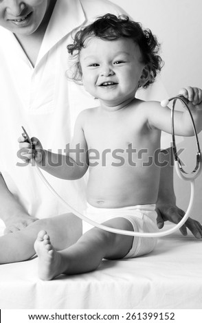 Cheerfu child at the doktor.Playing with stethoscope.