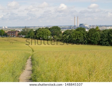 A landscape view of the riverside industry seen from a field / Field of view