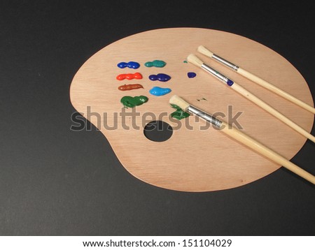 An image showing an artists equipment, Paint palette, brushes and paints / Palette for a painter