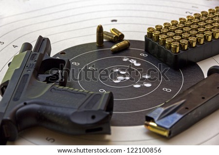 gun and ammunition over bulls eye score