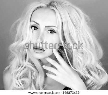 woman;s face with hand and curly hair black and white portrait