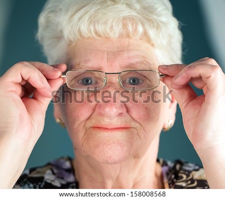 old smiling woman in glasses .