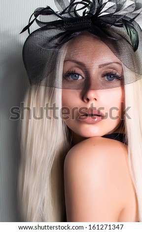 beautiful young woman in hat with veil .