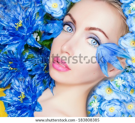 beauty face and blue flowers close up