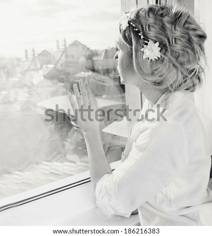 beautiful woman at window black and white