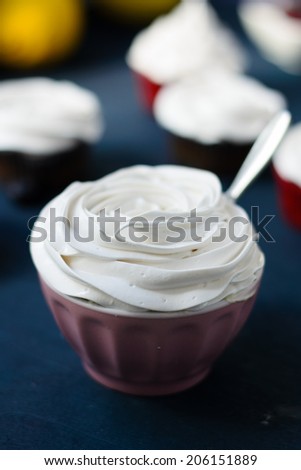 Lemon cupcakes with bilberry filled lemon curd and meringue frosting