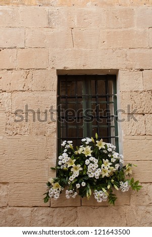Isolated window with large bouquet of white and yellow flowers in the window sill