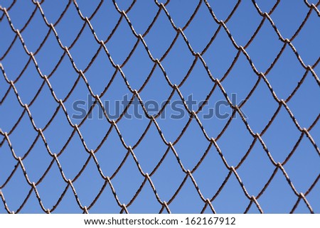 Chain link fence and blue sky.