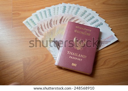 Thai money and passport ready to travel.