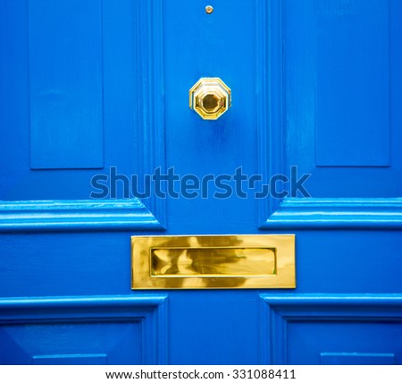 blue handle  in london antique  door  rusty  brass nail and light