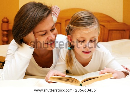 Mom and daughter reading   together a funny book