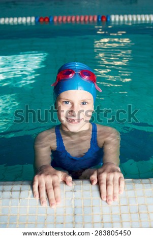 Swimmer preparing to swim on his back. Holding of competitions in swimming. Girl preparing to start.