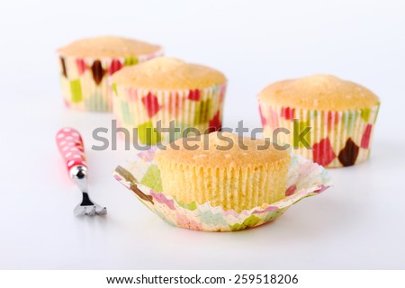 Fresh baked cupcakes without decoration on white background