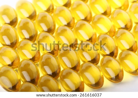 Cod liver oil omega 3 gel capsules line up to a background