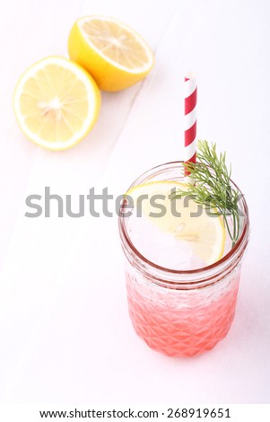 cold soft drink,ice and soda, from strawberry syrup garnish with lemon and dill
