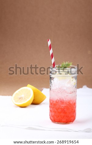 cold soft drink,ice and soda, from strawberry syrup garnish with lemon and dill