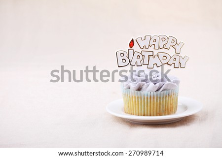 vanilla cupcake frosting with buttercream, flower shape, decorated with happy birthday label