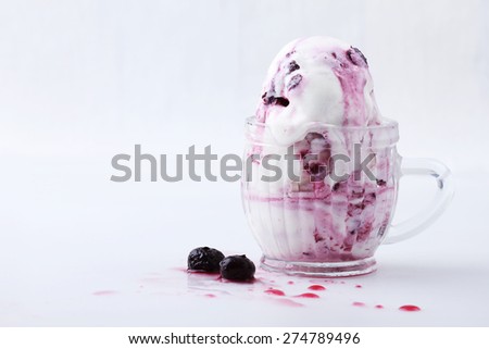 blueberry yogurt ice cream melting in vintage cup