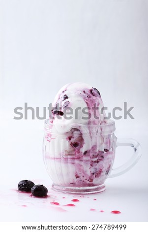 blueberry yogurt ice cream melting in vintage cup