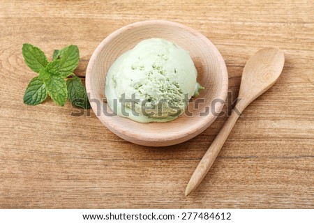green matcha tea ice cream in small wooden cup
