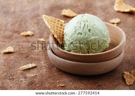 green tea ice cream in wooden small bowl