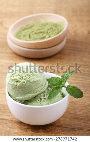 green tea ice cream in white remekin with mint