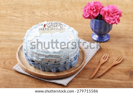 beautiful decorated cake with birthday label on wooden table