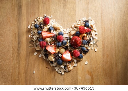 granola healthy snack with fresh berry in heart shaped