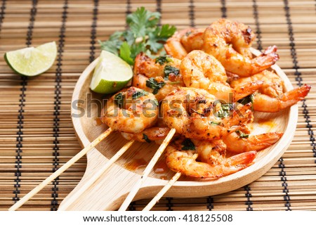 shrimp sriracha kebabs with lime and cilantro leaves