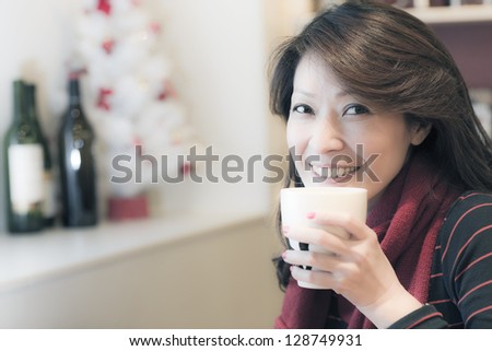 Young woman at home sipping tea from a cup