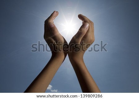 hand sun and blue sky / hand sun and blue sky showing freedom or solar power concept