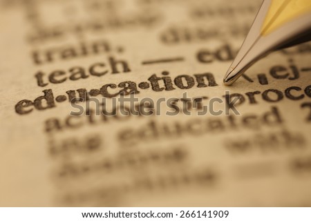 Education pen nib pointing to the words in the dictionary, shot with very shallow depth of field,