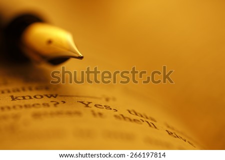 Old Books and Pen , shot with very shallow depth of field, Gold tone