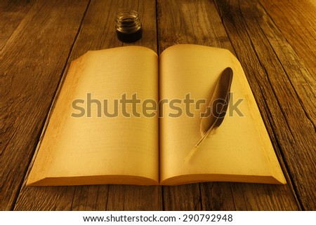 Quill and old books in the old wooden table