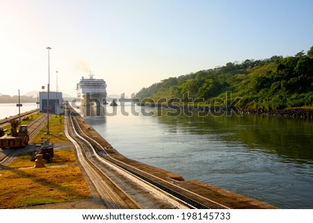 Cruise ship enters the Miraflores lock in the Panama Canal. Early morning on a beautiful sunny day in Panama.