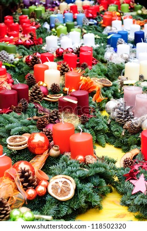 colorful Christmas candles and balls sold on the market. Christmas market. Beautiful colored candles on sales.