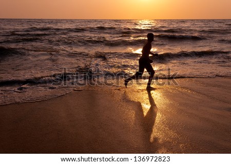 silhouette of male runner during sunset, Beautiful Afternoon by the sea in summer. Cherai beach Kerala India