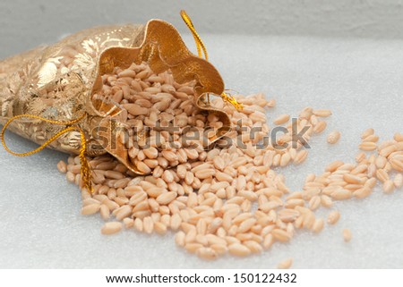 Wheat grain on white background. Wheat in bag. Wheat grains filled in a golden sack