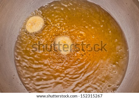 Coconut oil. close up of a frying pan with boiling oil. oil and water.