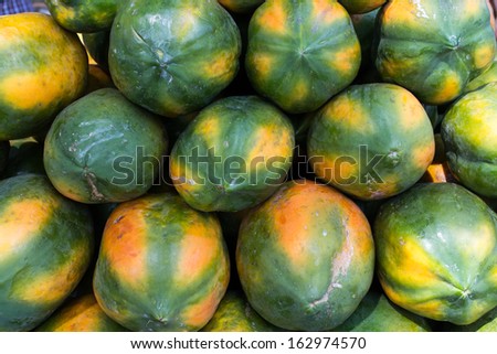large group of fresh ripe papaya displayed for sale in market. Raw healthy fruit. Papaya spa and resorts