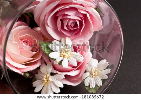 flower vase with beautiful red flowers. artificial pink paper rose flowers.
