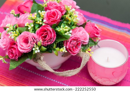 flowers basket. Festive table setting with basket of flowers and candle