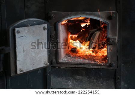 Wood burning inside the bio fuel boiler. renewable source of energy. green environmentally friendly fuel.