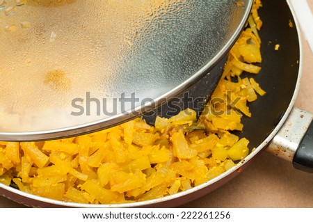 cooked vegetable in frying pan. steam cooked